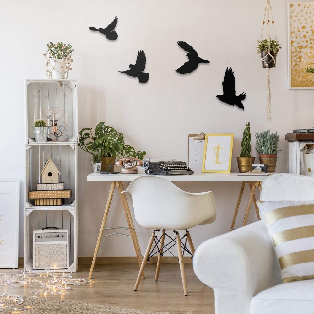 Modern home office with white furniture, plants, and decorative wall art.

