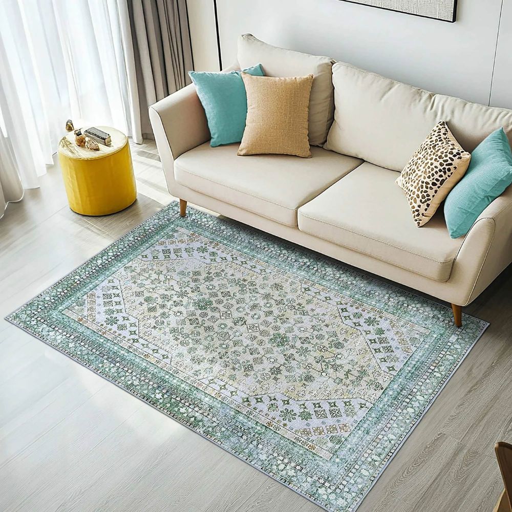 Living room with a beige sofa, patterned rug, and decorative pillows.

