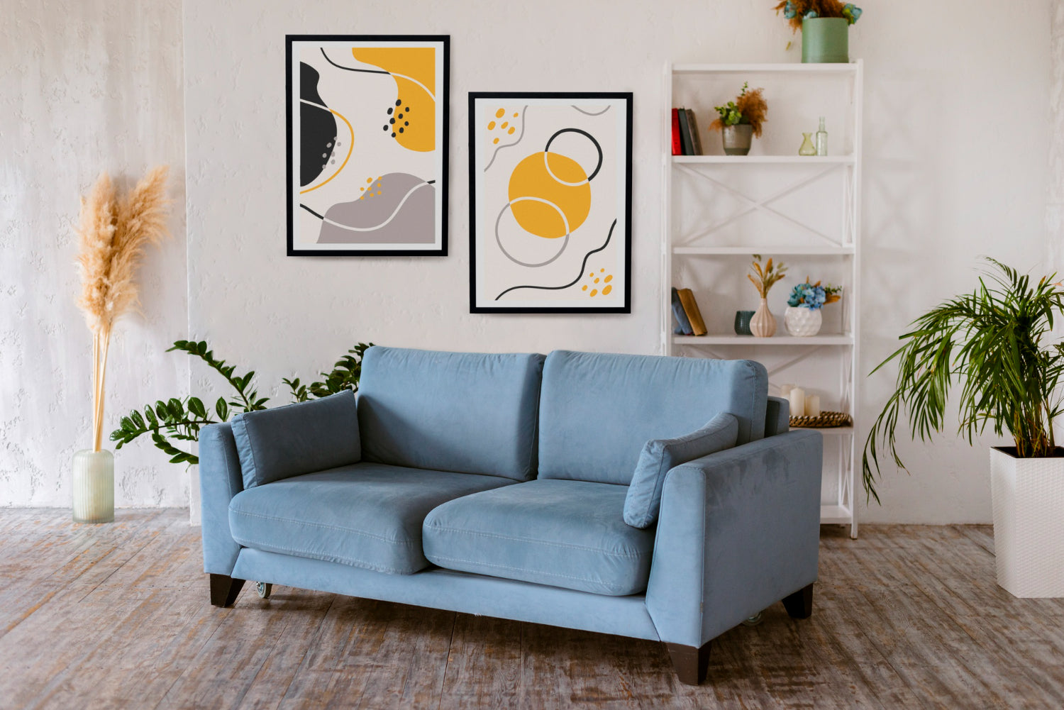 Blue sofa in a living room with abstract art and plants

